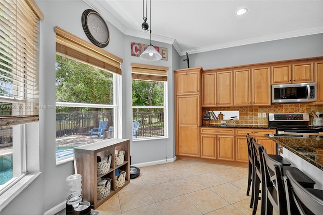 1086 Grove Park Cir, Boynton Beach, FL 33436 - kitchen with stainless steel appliances, crown molding, light tile patterned floors, healthy amount of natural light, and backsplash