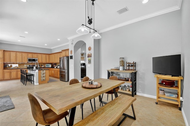 1086 Grove Park Cir, Boynton Beach, FL 33436 - dining room featuring arched walkways, crown molding, light tile patterned flooring, and recessed lighting
