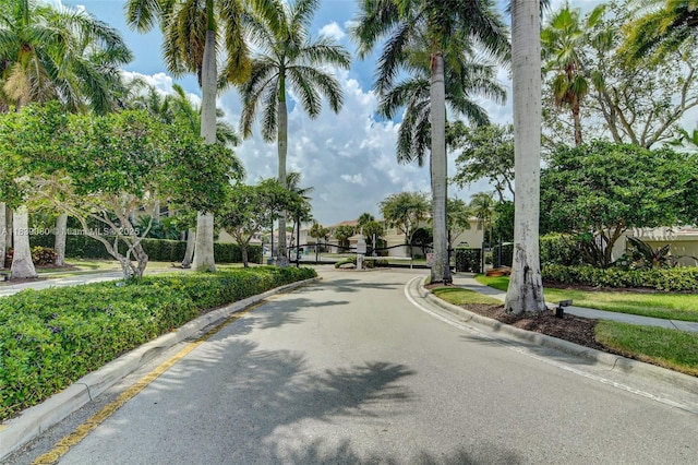 1086 Grove Park Cir, Boynton Beach, FL 33436 - view of asphalt street featuring curbs, sidewalks, and a gated entry