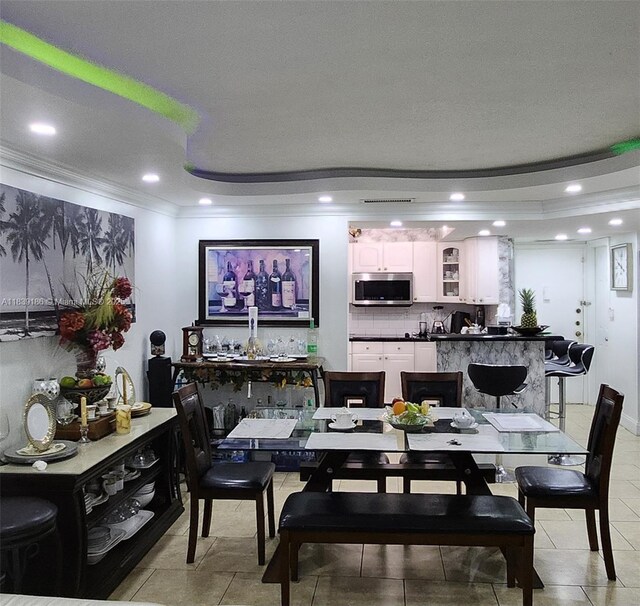 2750 NE 183rd St Unit 1701, Aventura, FL 33160 - dining room featuring crown molding, a raised ceiling, recessed lighting, and light tile patterned flooring