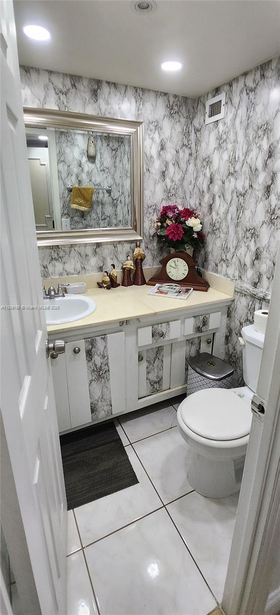 2750 NE 183rd St Unit 1701, Aventura, FL 33160 - half bathroom with vanity, tile patterned floors, and tile walls