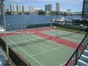 2750 NE 183rd St Unit 1701, Aventura, FL 33160 - view of tennis court featuring a water view, a view of skyline, and community basketball court