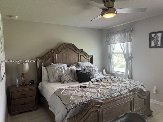 6349 Topsail Dr, West Palm Beach, FL 33413 - bedroom with light wood-type flooring, a ceiling fan, and a textured ceiling