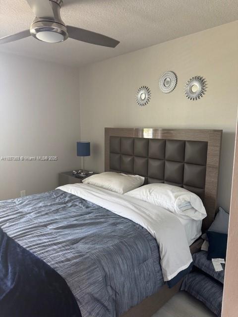 6349 Topsail Dr, West Palm Beach, FL 33413 - bedroom with a textured ceiling and a ceiling fan