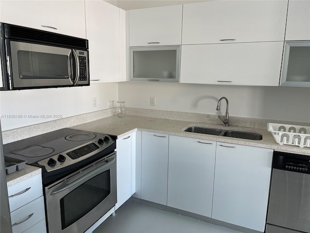 234 NE 3rd St Unit 905, Miami, FL 33132 - kitchen with appliances with stainless steel finishes, white cabinetry, and modern cabinets