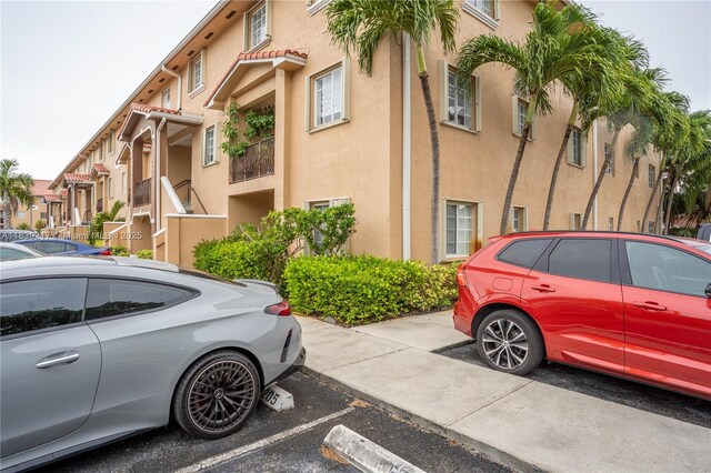 17425 NW 75th Pl Unit 101, Hialeah, FL 33015 - view of building exterior featuring uncovered parking