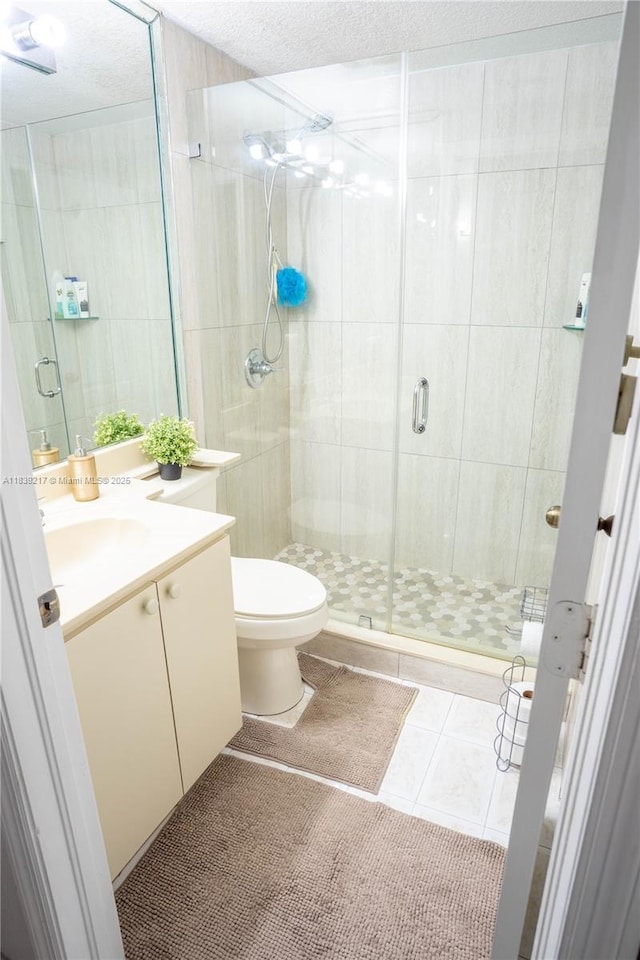 17425 NW 75th Pl Unit 101, Hialeah, FL 33015 - full bath with vanity, a textured ceiling, a stall shower, and tile patterned flooring