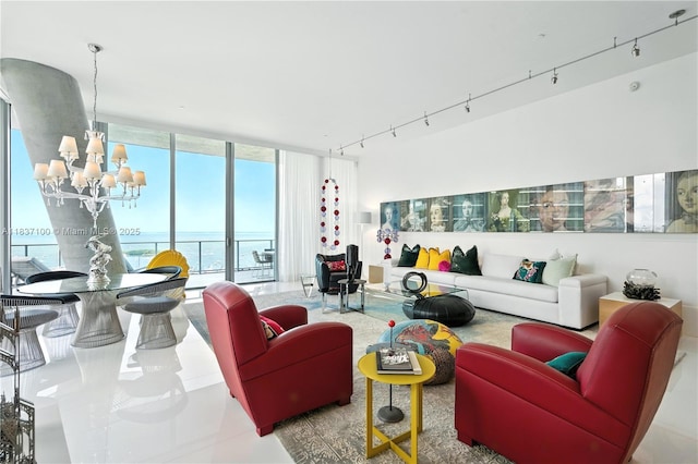 2675 S Bayshore Dr Unit 1601S, Miami, FL 33133 - living area featuring rail lighting, expansive windows, a chandelier, and a water view