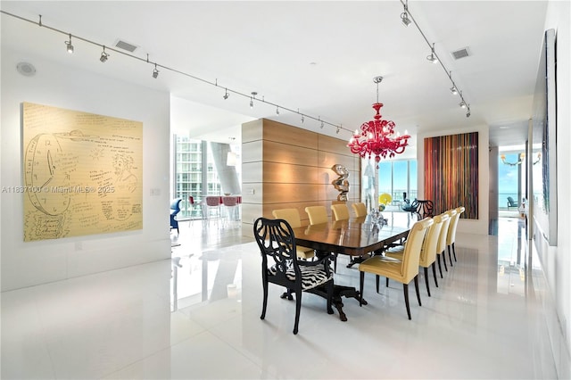 2675 S Bayshore Dr Unit 1601S, Miami, FL 33133 - dining space featuring rail lighting, light tile patterned flooring, a chandelier, and floor to ceiling windows