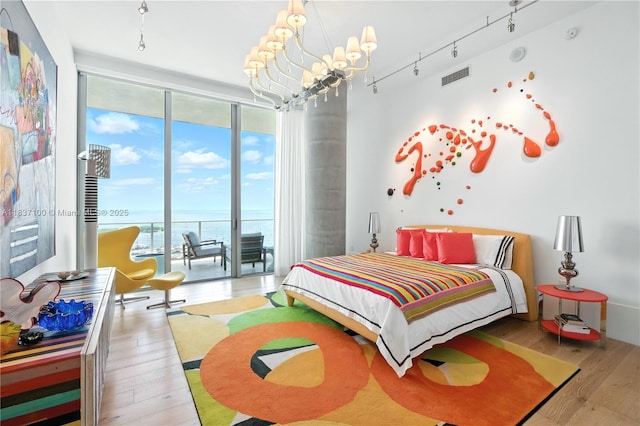 2675 S Bayshore Dr Unit 1601S, Miami, FL 33133 - bedroom with a wall of windows, access to outside, multiple windows, wood finished floors, and a chandelier