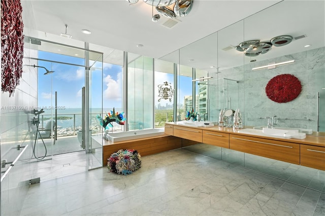 2675 S Bayshore Dr Unit 1601S, Miami, FL 33133 - full bath with double vanity, a bath, a stall shower, marble tiled floors, and plenty of natural light