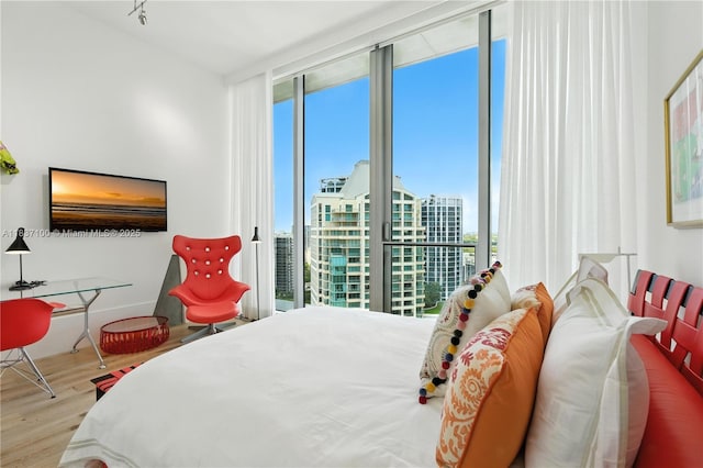 2675 S Bayshore Dr Unit 1601S, Miami, FL 33133 - bedroom featuring a wall of windows, wood finished floors, and a view of city