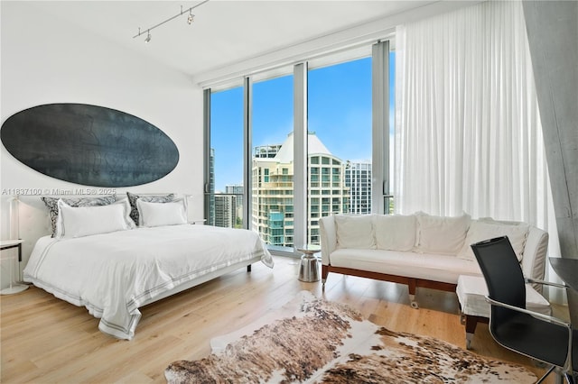 2675 S Bayshore Dr Unit 1601S, Miami, FL 33133 - bedroom with a wall of windows, wood finished floors, and track lighting