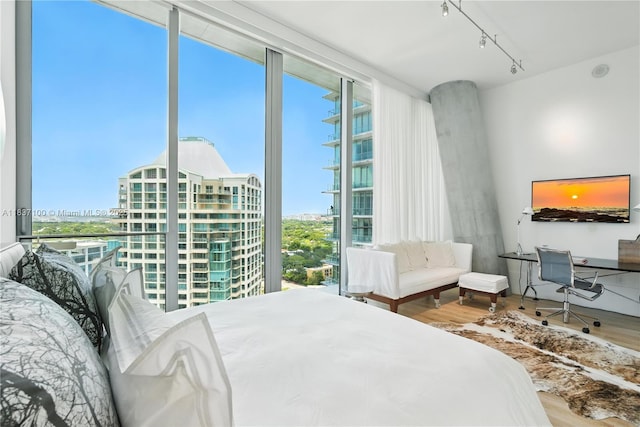 2675 S Bayshore Dr Unit 1601S, Miami, FL 33133 - bedroom featuring wood finished floors, track lighting, floor to ceiling windows, an office area, and a city view