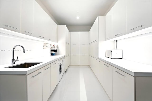 2675 S Bayshore Dr Unit 1601S, Miami, FL 33133 - kitchen with white microwave, light countertops, light tile patterned floors, recessed lighting, and washer / dryer