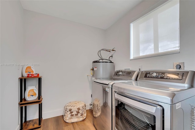 3141 SW 20th St, Fort Lauderdale, FL 33312 - laundry area with washing machine and clothes dryer, wood finished floors, and water heater