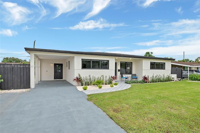 3141 SW 20th St, Fort Lauderdale, FL 33312 - view of front of home featuring concrete driveway, an attached carport, and stucco siding