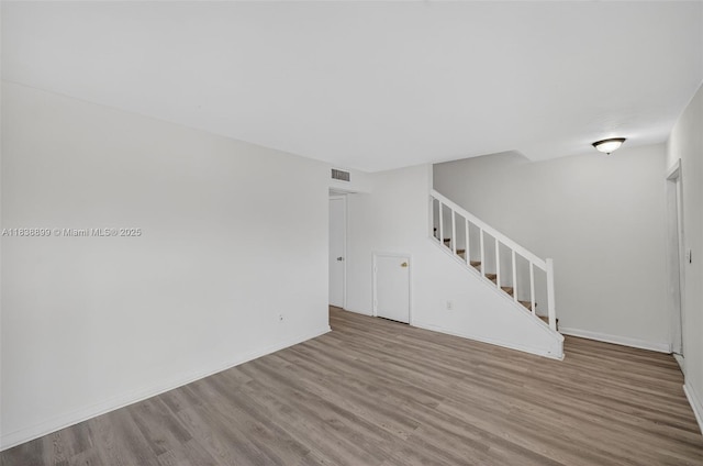 2767 NW 197th Ter, Miami Gardens, FL 33056 - unfurnished room with stairs and wood finished floors