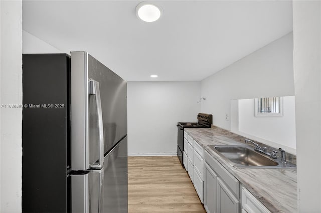 2767 NW 197th Ter, Miami Gardens, FL 33056 - kitchen featuring freestanding refrigerator, electric stove, light wood finished floors, and light countertops