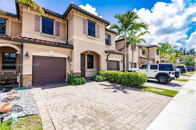 6586 S Anise Ct, Davie, FL 33314 - mediterranean / spanish house with a tiled roof, stucco siding, a garage, and decorative driveway