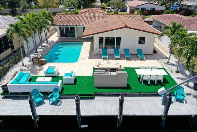 2321 SE 15th St, Pompano Beach, FL 33062 - rear view of property featuring stucco siding, a fenced backyard, a patio, and a residential view