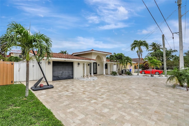 2321 SE 15th St, Pompano Beach, FL 33062 - mediterranean / spanish home featuring a tiled roof, stucco siding, a garage, and driveway