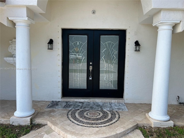 2321 SE 15th St, Pompano Beach, FL 33062 - view of exterior entry with french doors and stucco siding