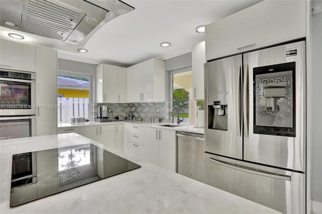 2321 SE 15th St, Pompano Beach, FL 33062 - kitchen with appliances with stainless steel finishes, ventilation hood, white cabinets, decorative backsplash, and recessed lighting