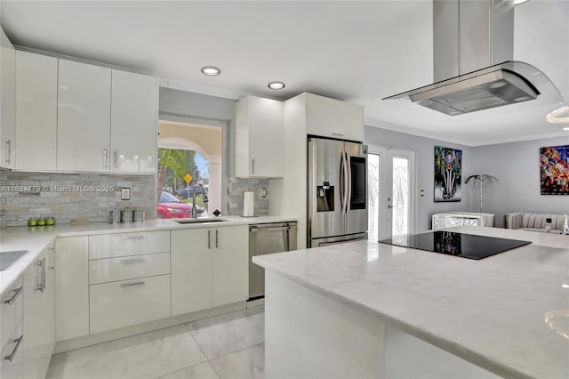 2321 SE 15th St, Pompano Beach, FL 33062 - kitchen with appliances with stainless steel finishes, island exhaust hood, backsplash, recessed lighting, and white cabinetry
