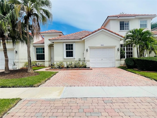 2817 SW 187th Ave, Miramar, FL 33029 - mediterranean / spanish-style home with a tile roof, decorative driveway, stucco siding, and a garage