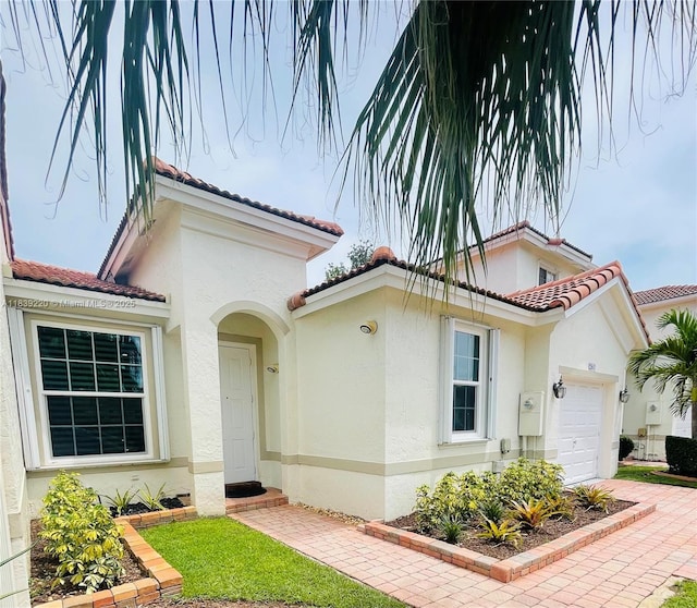2817 SW 187th Ave, Miramar, FL 33029 - mediterranean / spanish-style house with an attached garage, stucco siding, a tile roof, and driveway