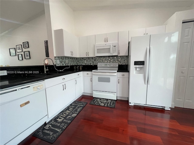 2817 SW 187th Ave, Miramar, FL 33029 - kitchen featuring white appliances, dark wood-style flooring, dark countertops, backsplash, and white cabinetry