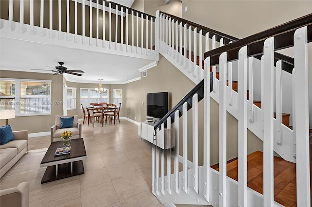 10871 SW 11th Mnr, Davie, FL 33324 - living area featuring a chandelier, stairs, tile patterned flooring, crown molding, and a ceiling fan