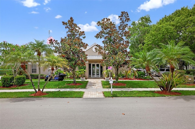 10871 SW 11th Mnr, Davie, FL 33324 - obstructed view of property featuring french doors and a front lawn