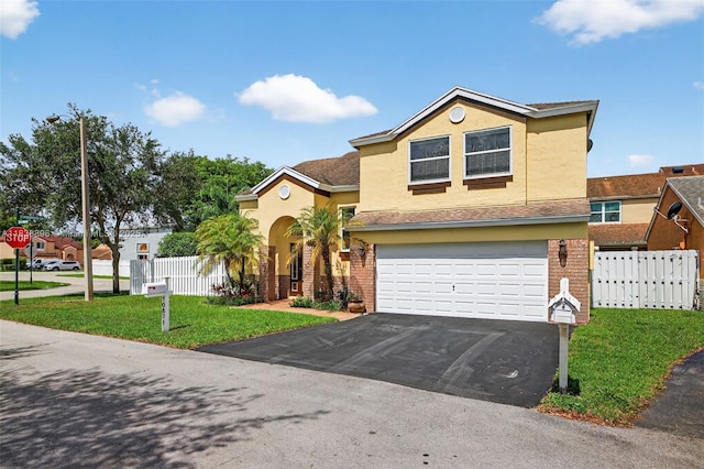 10871 SW 11th Mnr, Davie, FL 33324 - view of front of property featuring asphalt driveway, stucco siding, an attached garage, and brick siding