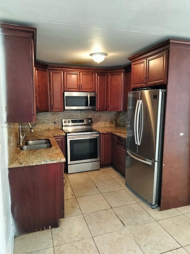 6023 SW 69th St Unit 78, South Miami, FL 33143 - kitchen with appliances with stainless steel finishes, light tile patterned floors, light stone counters, and tasteful backsplash