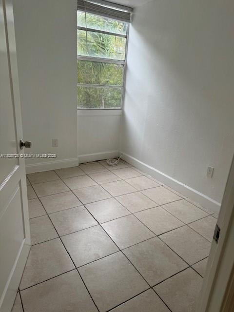 6023 SW 69th St Unit 78, South Miami, FL 33143 - empty room featuring light tile patterned flooring and baseboards