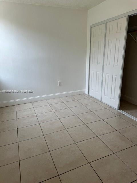 6023 SW 69th St Unit 78, South Miami, FL 33143 - unfurnished bedroom featuring light tile patterned floors and a closet
