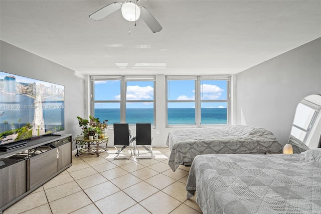 2899 Collins Ave Unit 931, Miami Beach, FL 33140 - bedroom featuring a water view, light tile patterned flooring, and ceiling fan