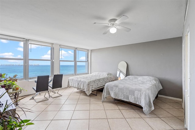 2899 Collins Ave Unit 931, Miami Beach, FL 33140 - bedroom with a water view, light tile patterned floors, and a ceiling fan