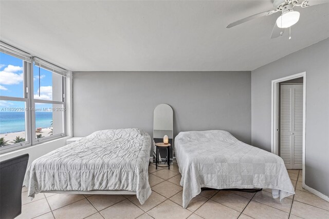 2899 Collins Ave Unit 931, Miami Beach, FL 33140 - tiled bedroom with a ceiling fan and a water view