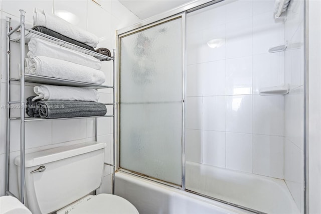 2899 Collins Ave Unit 931, Miami Beach, FL 33140 - bathroom featuring toilet and bath / shower combo with glass door