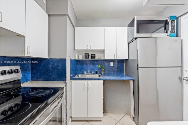 2899 Collins Ave Unit 931, Miami Beach, FL 33140 - kitchen featuring appliances with stainless steel finishes, decorative backsplash, white cabinets, open shelves, and light tile patterned floors