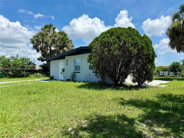 3460 Normandy Dr, Port Charlotte, FL 33952 - view of side of property featuring a yard and stucco siding