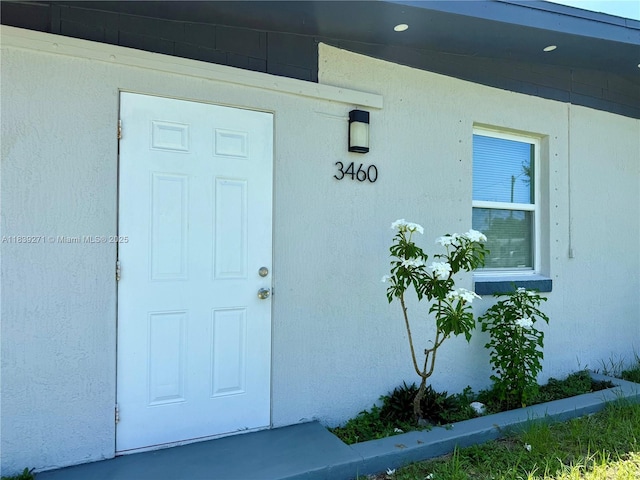 3460 Normandy Dr, Port Charlotte, FL 33952 - view of exterior entry featuring stucco siding
