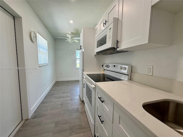 3460 Normandy Dr, Port Charlotte, FL 33952 - kitchen featuring white appliances, light countertops, a ceiling fan, white cabinets, and recessed lighting