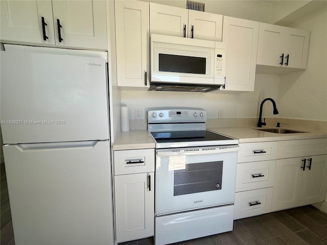 3460 Normandy Dr, Port Charlotte, FL 33952 - kitchen featuring white appliances, light countertops, dark wood-type flooring, and white cabinetry