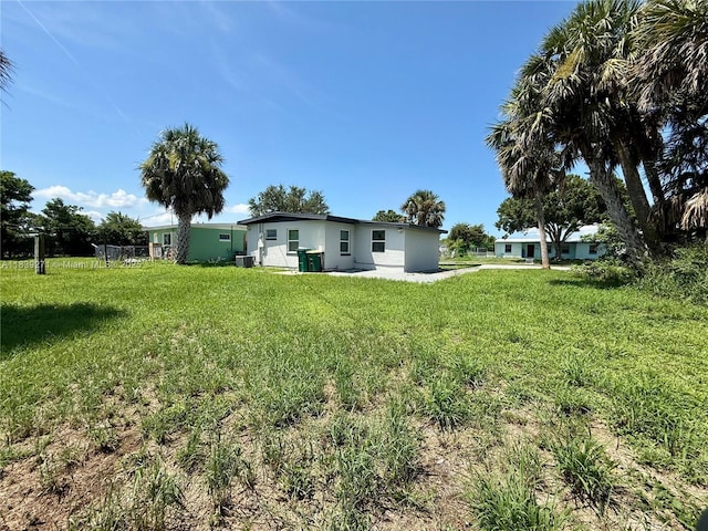 3460 Normandy Dr, Port Charlotte, FL 33952 - rear view of house with a lawn and stucco siding