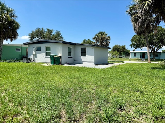 3460 Normandy Dr, Port Charlotte, FL 33952 - back of house featuring stucco siding and a yard