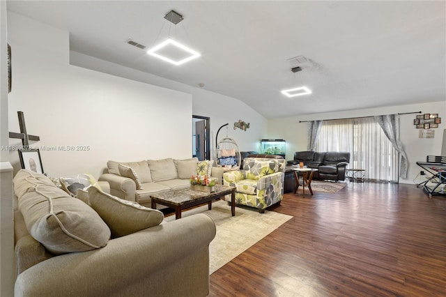 5506 Redhawk Dr, New Port Richey, FL 34655 - living area featuring dark wood-style flooring and vaulted ceiling